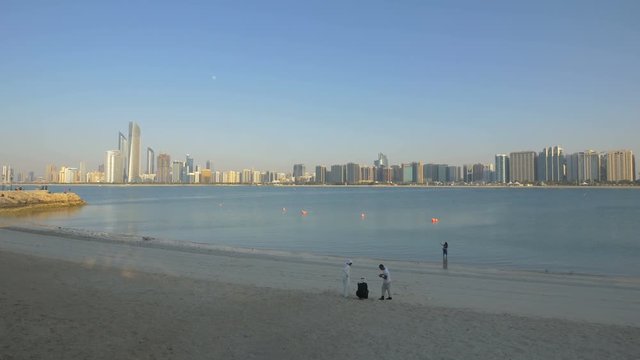 People relaxing on Breakwater Beach in Abu Dhabi