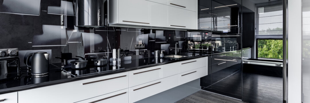 Contemporary kitchen with white cupboards