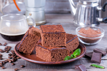 Homemade brownies on plate on wood table.