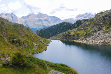 Fototapeta na wymiar Little mountain lake with panorama on dolomites - Madonna di Campiglio - Trentino Alto Adige