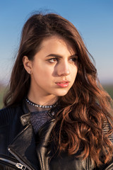 Portrait of beautiful young woman dressed with a black leather jacket