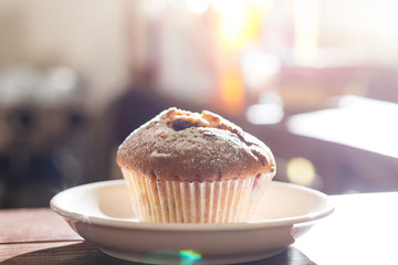 Delicious home-made blueberry muffins on a wooden background