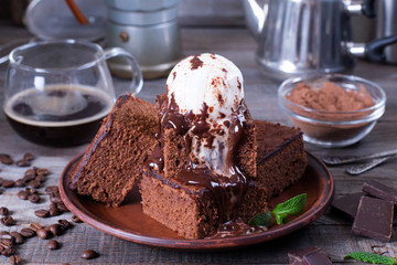 Chocolate cake with ice cream and chocolate sauce