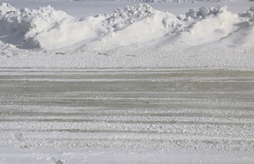 snowy road. road in a snowy field covered with snow. an icy road between snowdrifts.