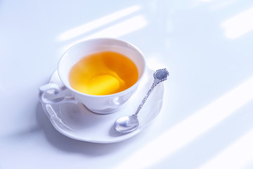hot tea pouring into white cup, ready to drink