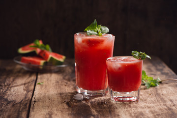 Refreshing summer watermelon juice in glasses with slices of watermelon
