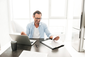 Fototapeta premium Handsome mature man working with documents