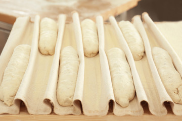 Fototapeta premium Raw fresh bread on table in bakery