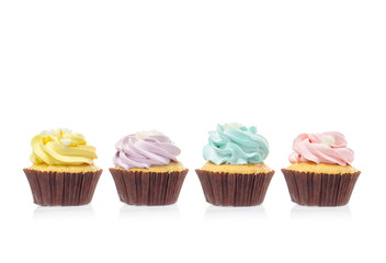 macro close up of four cupcakes with cream and sugar isolated on white background, File contains a clipping path