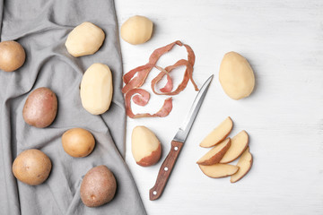 Composition with raw potatoes on wooden table