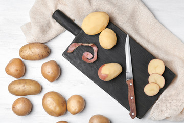 Composition with raw potatoes on wooden table
