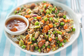 Quinoa, spelt, peanuts, almond, pistachios salad with soy and ginger dressing 