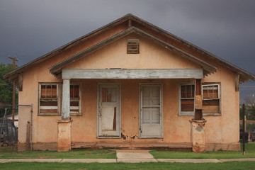 Landscape picture of an abandoned building on Route 66 against a grey sky captured in Tucumcari,...
