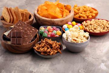 Salty snacks. Pretzels, chips, crackers in wooden bowls.