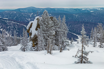 Fototapeta na wymiar View on the top of the Mount Utuya. Winter landscape in Altay Mountains. Russia, Kemerovo region, Sheregesh ski resort, March 2018.