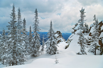 View on the top of the Mount Utuya. Winter forest landscape in Altay Mountains. Siberia, Kemerovo region, Sheregesh ski resort, March 2018.