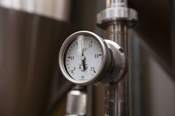 Pressure gauge (manometer) of white metal - brewing equipment. Close-up, macro.