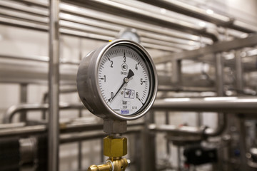Pressure gauge (manometer) of white metal -  brewing equipment. Close-up, macro.