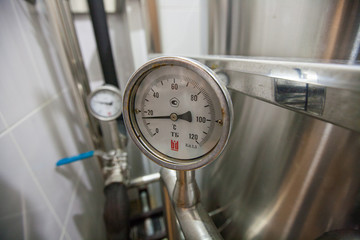 Pressure gauge (manometer) of white metal -  brewing equipment. Close-up, macro.
