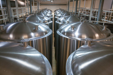 Huge Tanks of white metal, which brewed beer in the brewery, the top view
