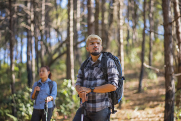 Close up of Hiking Couple backpacker in the pine forest.