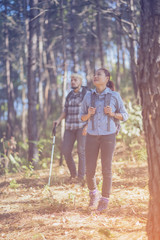 Fototapeta premium Hiking Couple backpacker in the pine forest.