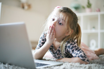 Shocking little girl with laptop.
