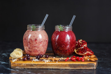 freshly prepared smoothies from banana with pomegranate and banana with blackberry in bottle. Diet, healthy lifestyle