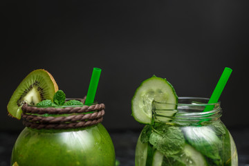 Blended green smoothie and detox with ingredients on table