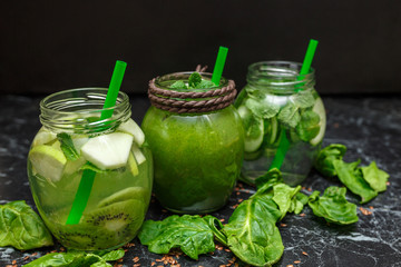 Blended green smoothie and detox with ingredients on table