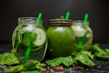 Blended green smoothie and detox with ingredients on table