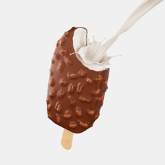 Chocolate ice cream bar and Milk splash with nut or almond on a wood stick