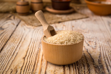 white rice in bowl on a wooden background. Healthy dietary cereals concept.