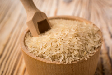 white rice in bowl on a wooden background. Healthy dietary cereals concept.