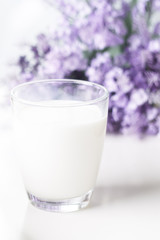 Breakfast, brunch, milk on white background with flowers