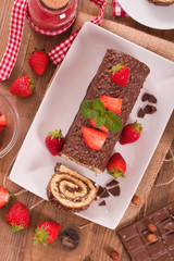 Chocolate roll with strawberries. 
