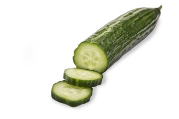 Cut cucumber with knife on the white