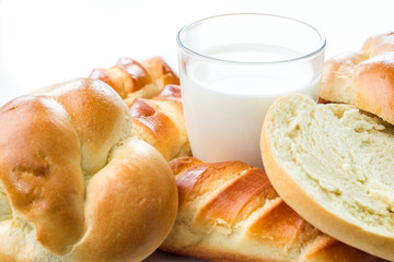 Breakfast, brunch, milk with homemade pastries on white background with flowers