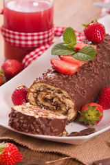 Chocolate roll with strawberries. 
