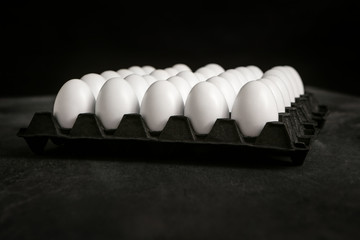 white eggs in a black tray