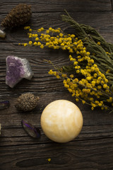 mystical picture of amethyst, crystals and flowers on a wooden table