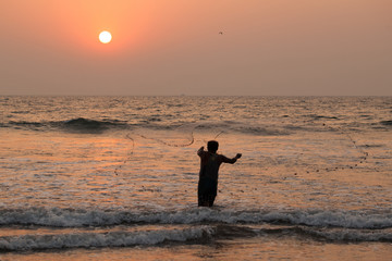 Fisherman throwing net 
