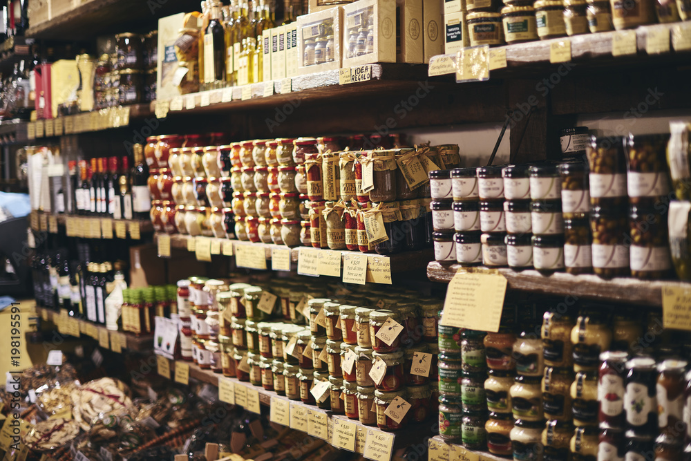 Wall mural jars of food in a delicatessen in italy