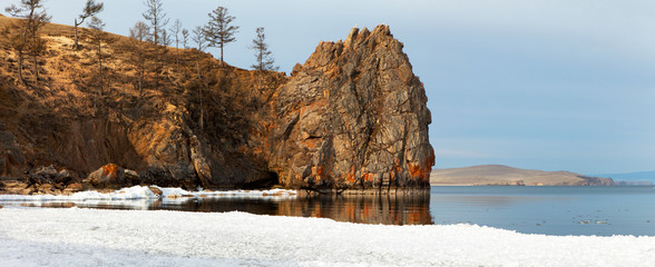 Spring morning at Lake Baikal. Olkhon Island. Melting ice floes on the beach near Cape Tataiskiy. Panoramic view