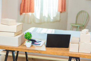 Home office, and bedroom, of young independent online business seller