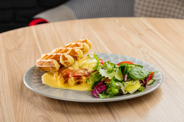 Savory Belgian waffles with mustard sauce and salad