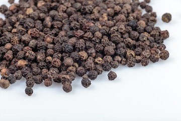 Scattered pea black hot pepper closeup