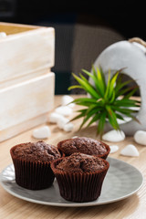 Fresh baked chocolate muffins on gray plate