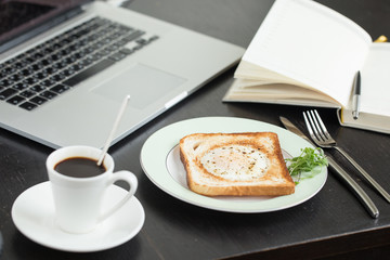 Business breakfast. Egg fried in toast with coffee