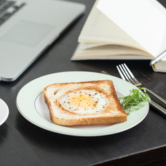 Business breakfast. Egg fried in toast with coffee